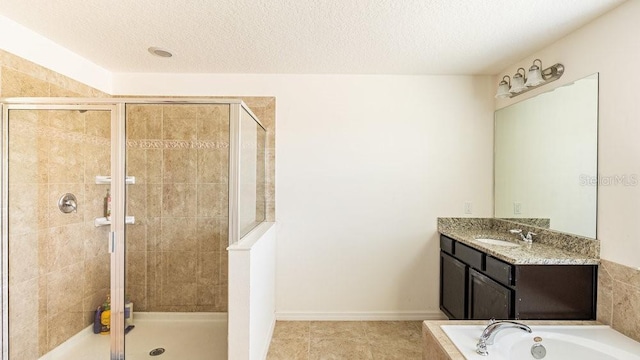 bathroom with vanity, shower with separate bathtub, a textured ceiling, and tile patterned floors