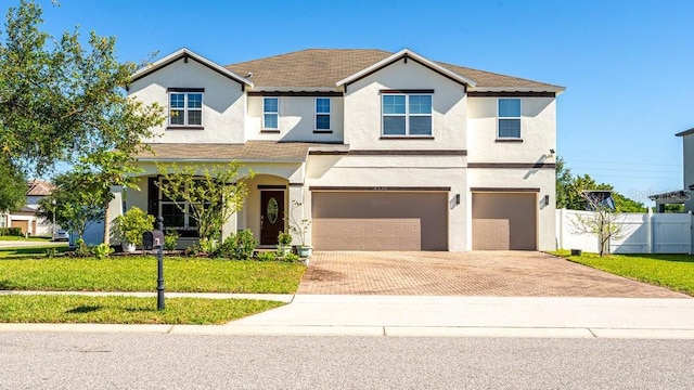 view of front of property featuring a front lawn and a garage