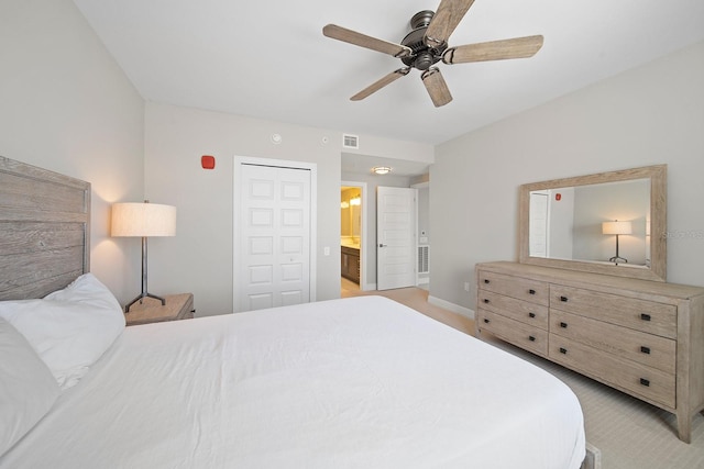 carpeted bedroom with connected bathroom, a closet, and ceiling fan