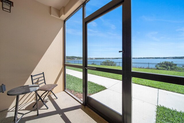 unfurnished sunroom with a water view