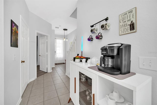 corridor featuring light tile flooring and wine cooler