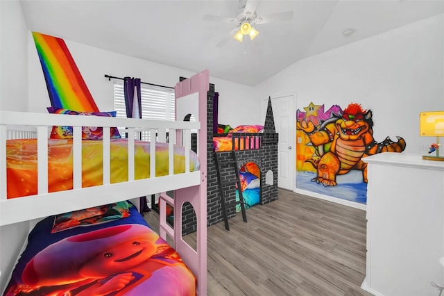 bedroom with ceiling fan, lofted ceiling, and light hardwood / wood-style flooring