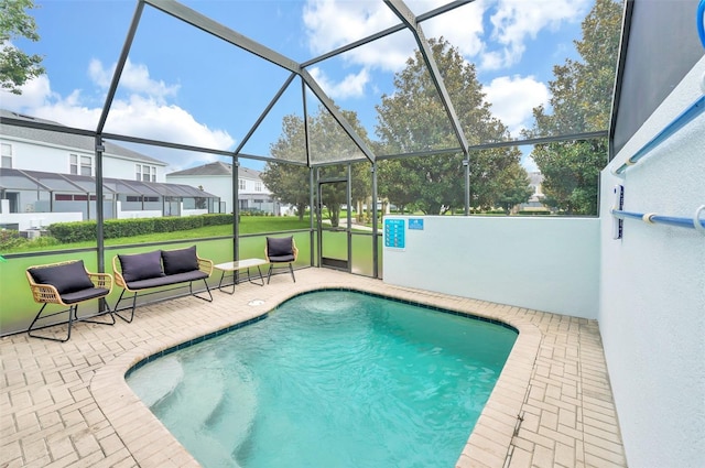 view of swimming pool with a lanai and a patio