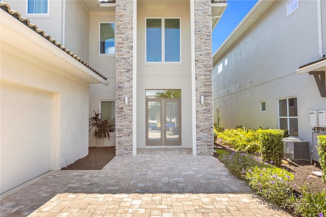 doorway to property with french doors and central air condition unit