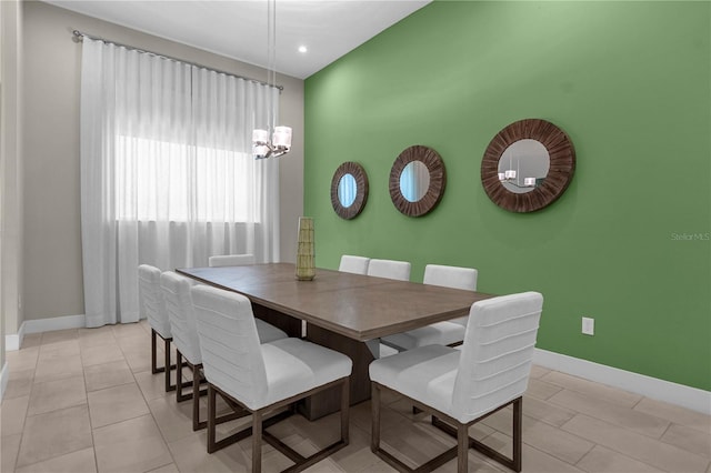 dining area with an inviting chandelier and light tile flooring