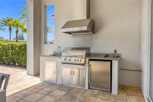 view of patio / terrace with sink, a grill, and an outdoor kitchen