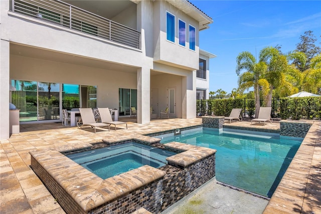 view of swimming pool featuring an in ground hot tub and a patio