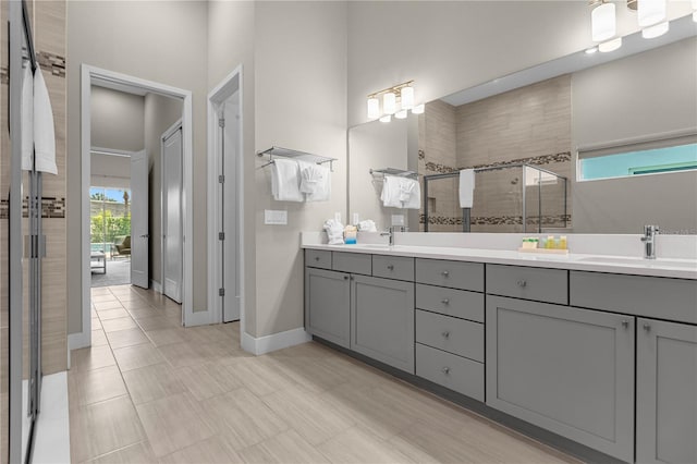 bathroom featuring walk in shower, tile flooring, and double sink vanity