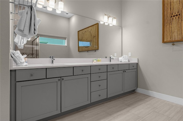 bathroom with dual sinks, tile flooring, and large vanity