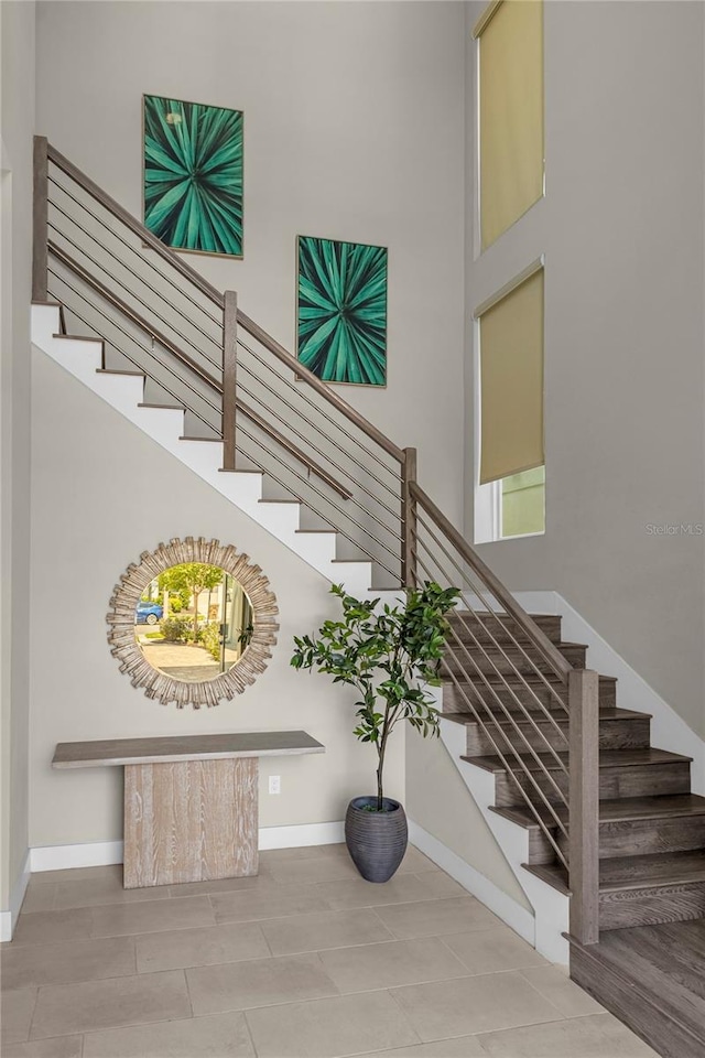 stairway featuring a high ceiling