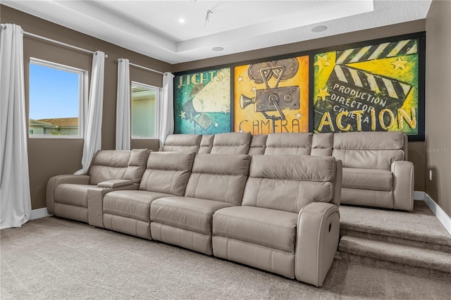 home theater featuring carpet flooring and a tray ceiling