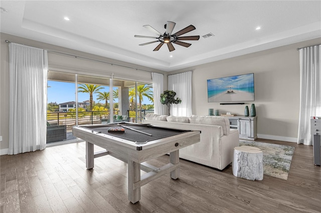 game room featuring hardwood / wood-style floors, ceiling fan, a raised ceiling, and billiards