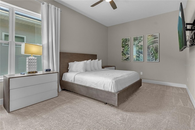 carpeted bedroom with ceiling fan and multiple windows