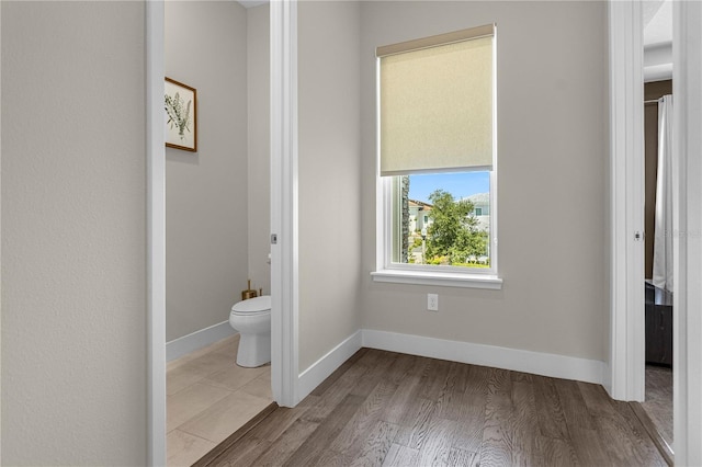 bathroom with tile flooring and toilet