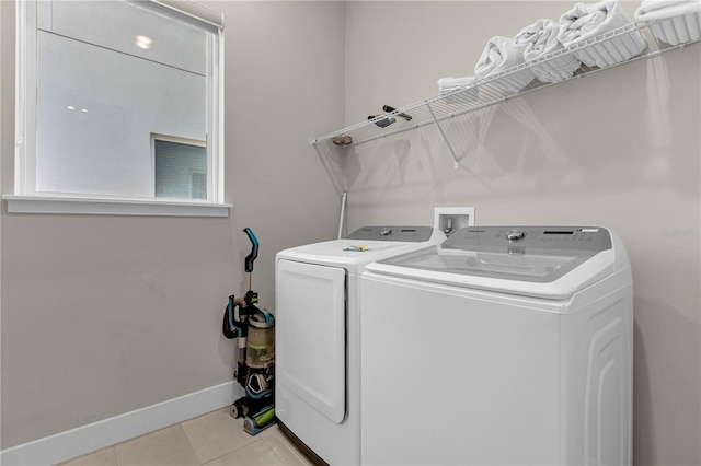 laundry room with washer and clothes dryer, hookup for a washing machine, and light tile flooring