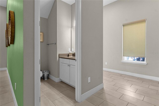 bathroom featuring tile flooring and vanity