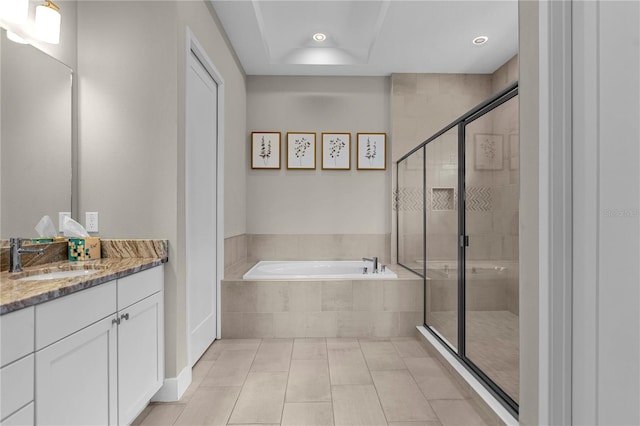 bathroom featuring tile floors, oversized vanity, and independent shower and bath