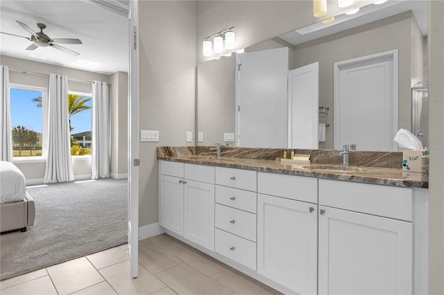 bathroom with dual sinks, oversized vanity, ceiling fan, and tile floors