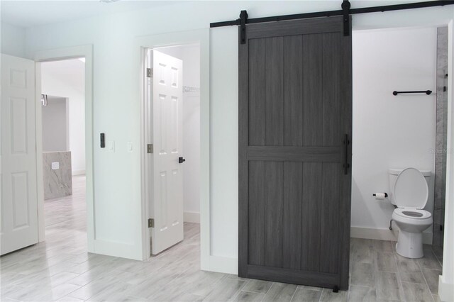 bathroom with wood-type flooring and toilet