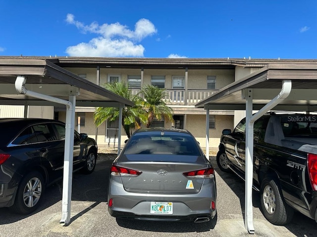 view of parking / parking lot featuring a carport