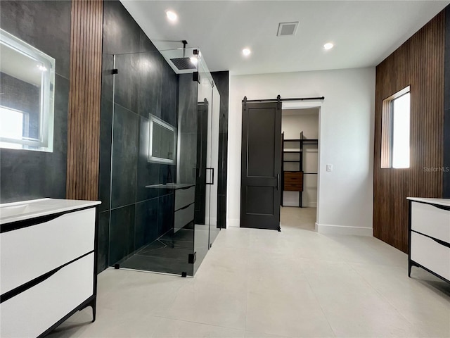 bathroom featuring walk in shower, tile flooring, and vanity