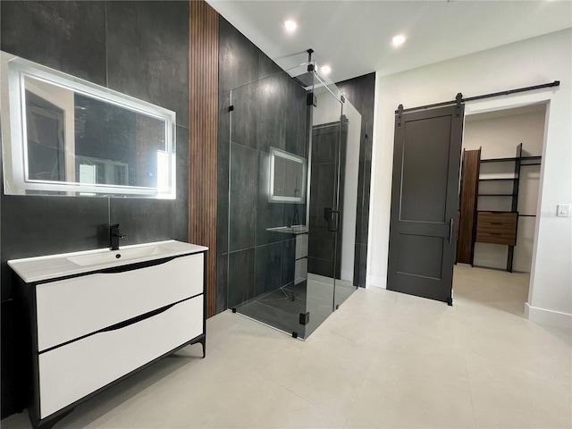 bathroom with tile flooring, walk in shower, and vanity