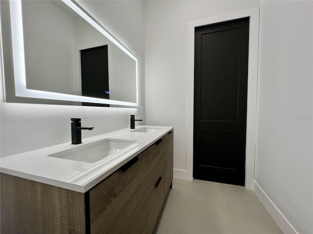 bathroom featuring double vanity and concrete floors