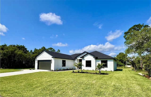 view of front of property with a front yard and a garage