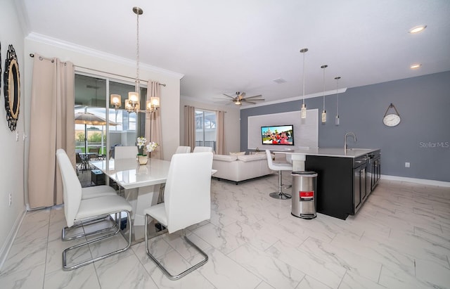 tiled dining room featuring sink, crown molding, and ceiling fan with notable chandelier