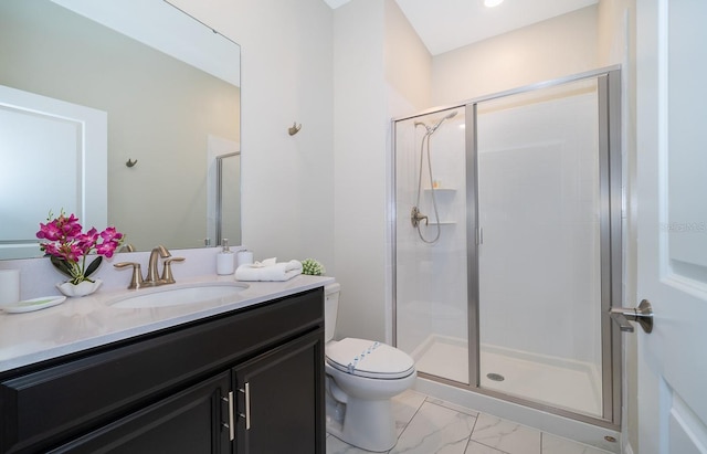 bathroom with tile flooring, toilet, vanity with extensive cabinet space, and an enclosed shower