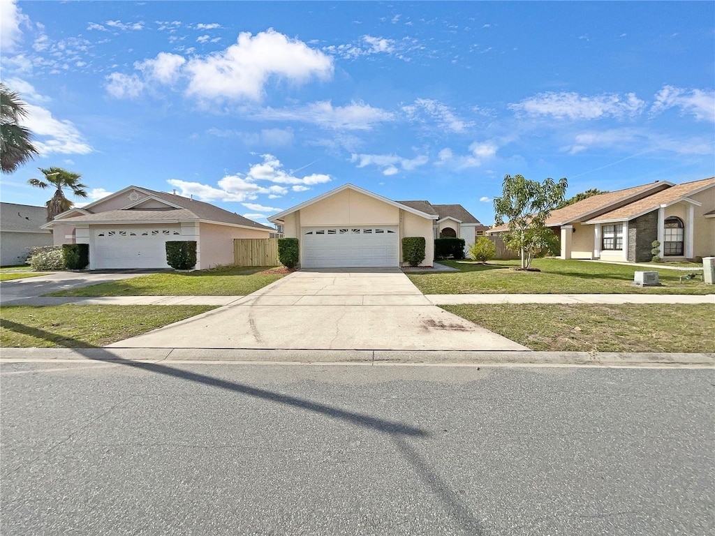 5304 Lonesome Dove Dr, Kissimmee, FL 34746 - ranch-style house with a front yard and a garage