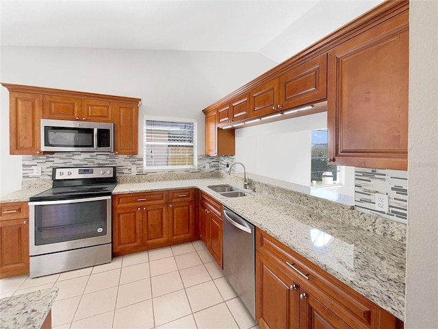 kitchen with sink, stainless steel appliances, lofted ceiling, and backsplash