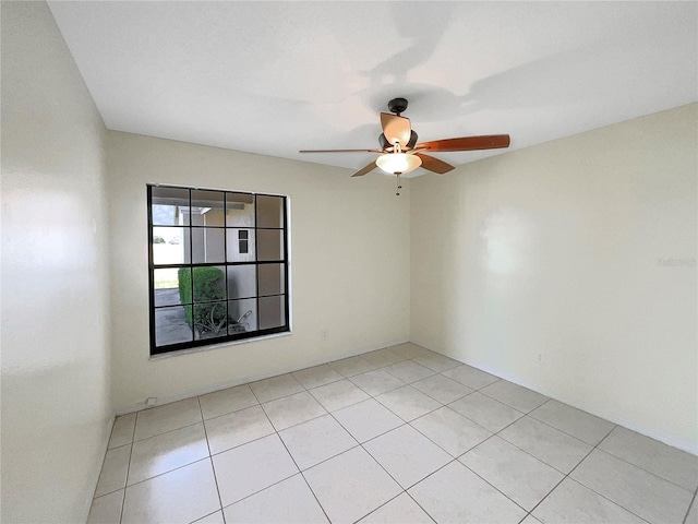 tiled spare room with ceiling fan