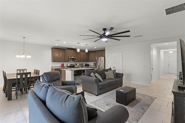687 Campo Ln, Davenport, FL 33837 - living room with a ceiling fan, light tile patterned floors, a chandelier, and recessed lighting