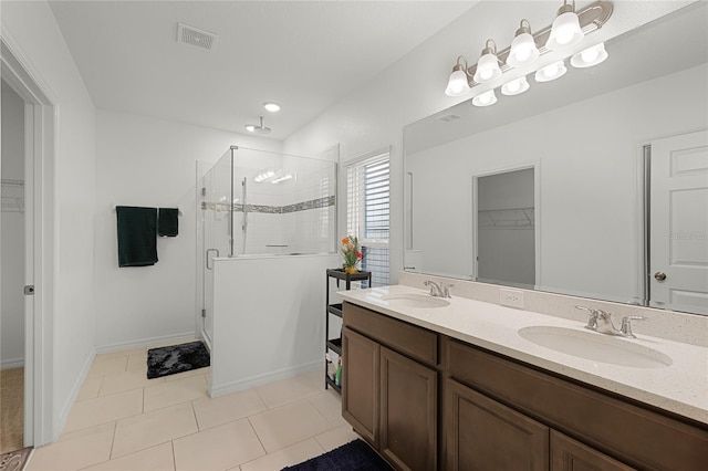 687 Campo Ln, Davenport, FL 33837 - bathroom featuring a stall shower, a walk in closet, double vanity, and tile patterned floors