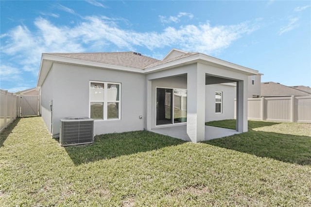 687 Campo Ln, Davenport, FL 33837 - back of property with stucco siding, a patio area, and a fenced backyard