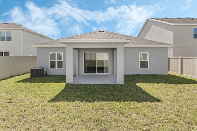 687 Campo Ln, Davenport, FL 33837 - rear view of property featuring a fenced backyard, a shingled roof, stucco siding, and a patio