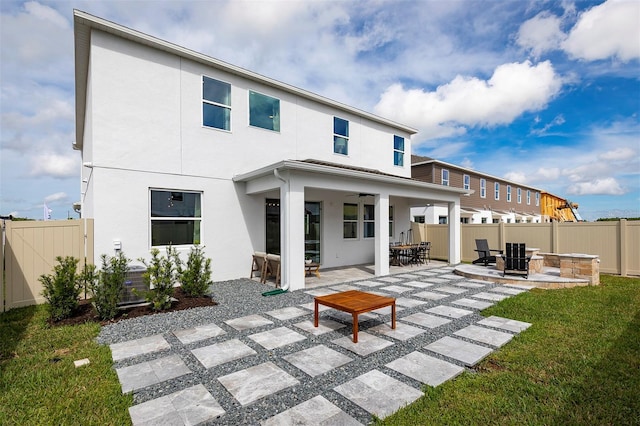 back of house with a lawn, a patio area, and ceiling fan