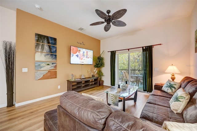 living room with light wood-type flooring and ceiling fan