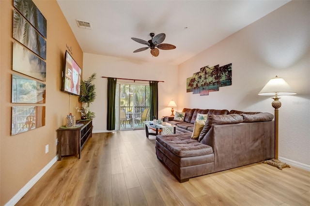 living room with light hardwood / wood-style flooring and ceiling fan