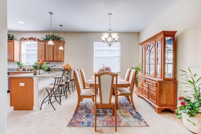 tiled dining room with a notable chandelier and a healthy amount of sunlight