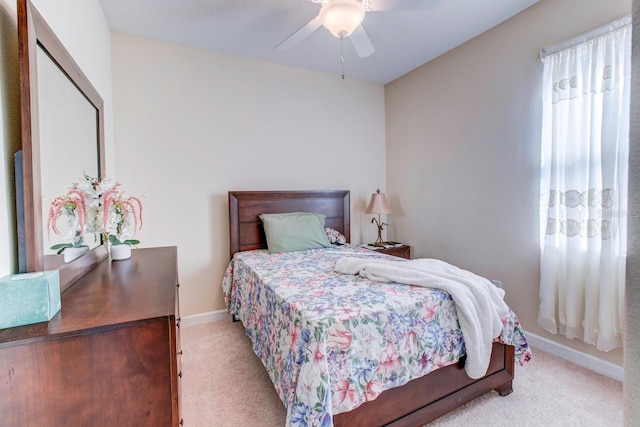 bedroom featuring light colored carpet and ceiling fan