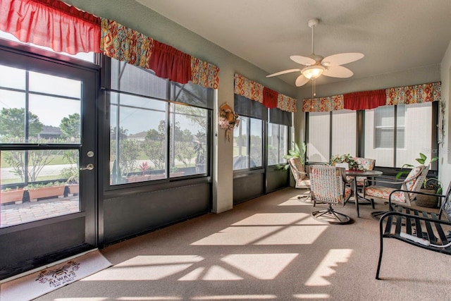 sunroom featuring ceiling fan