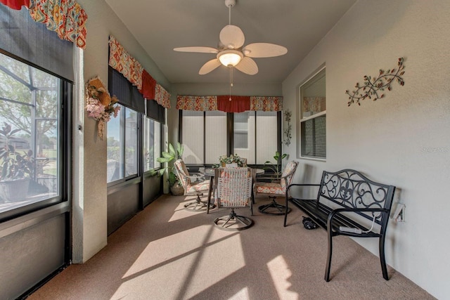 sunroom featuring ceiling fan