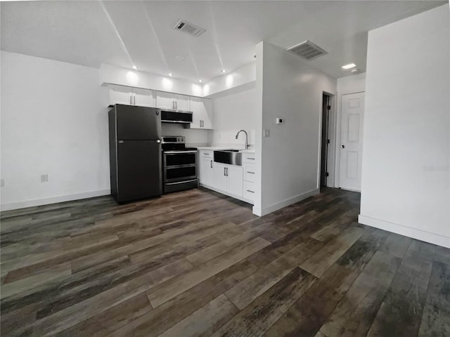 kitchen with appliances with stainless steel finishes, sink, and dark wood-type flooring