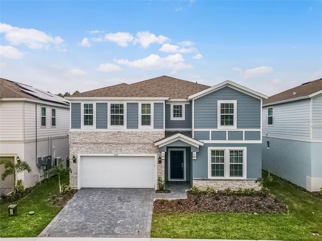 front of property featuring a garage and a front yard