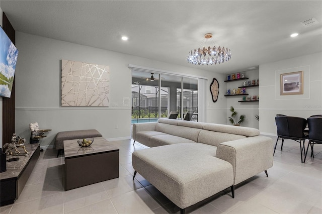 tiled living room featuring a notable chandelier