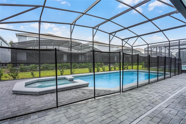 view of swimming pool featuring a patio area and a lanai