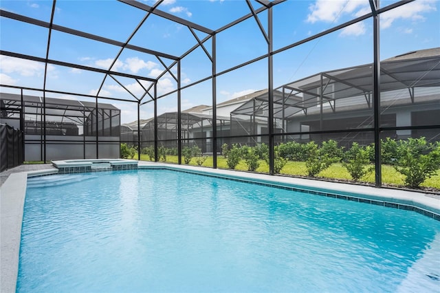 view of pool featuring a lanai and an in ground hot tub