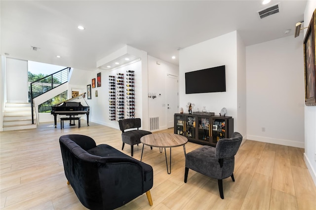 living room with floor to ceiling windows and light wood-type flooring